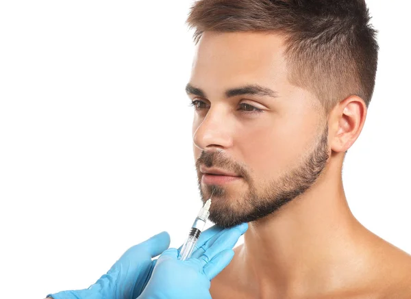 Handsome man receiving filler injection on white background — Stock Photo, Image