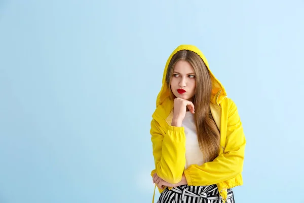 Thoughtful young woman on color background — Stock Photo, Image