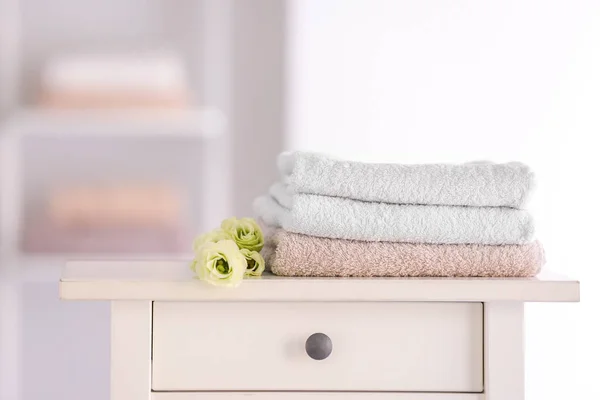 Soft clean towels on table in bathroom — Stock Photo, Image
