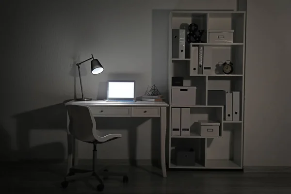 Akşam dizüstü bilgisayar ile modern işyeri — Stok fotoğraf
