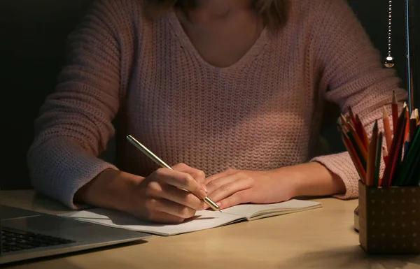 Vrouw werkt bij tafel in de avond — Stockfoto