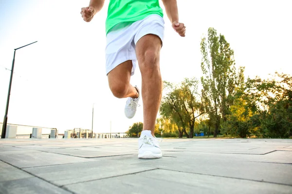 Handsome sporty man running outdoors — Stock Photo, Image