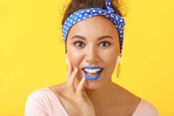 Portrait of surprised fashionable young African-American woman on color background — Stock Photo, Image