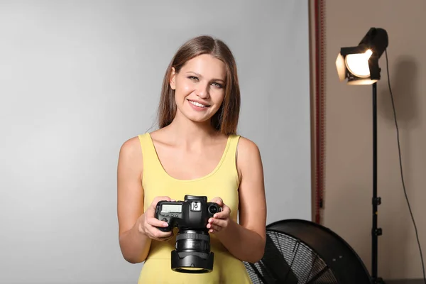 Beautiful female photographer in studio — Stock Photo, Image