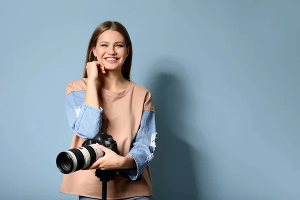 Beautiful female photographer on color background — Stock Photo, Image