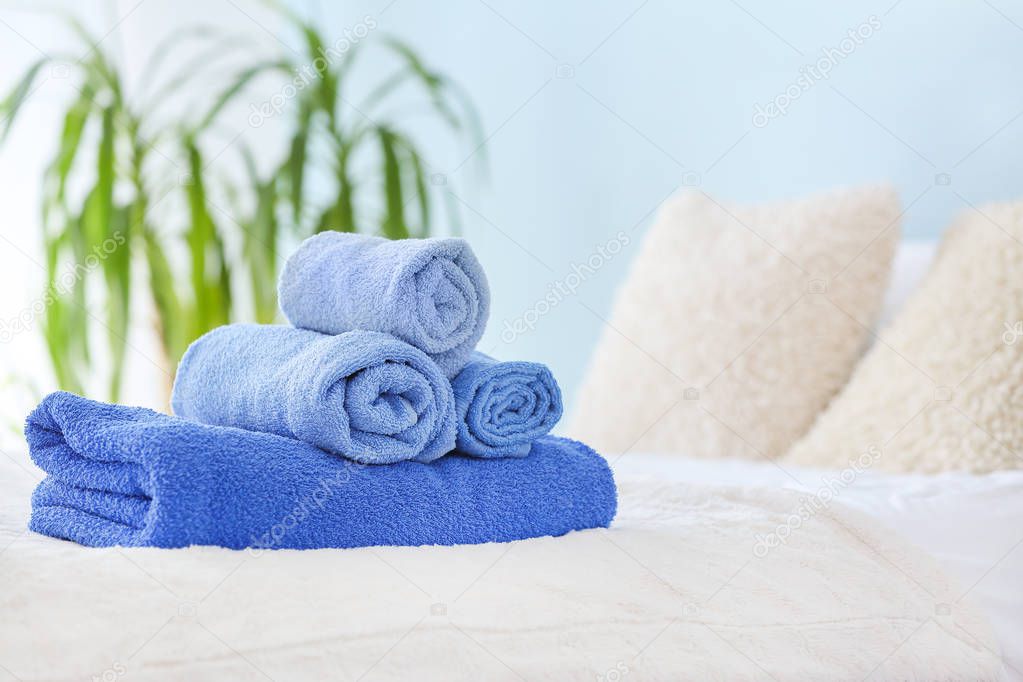 Soft clean towels on bed