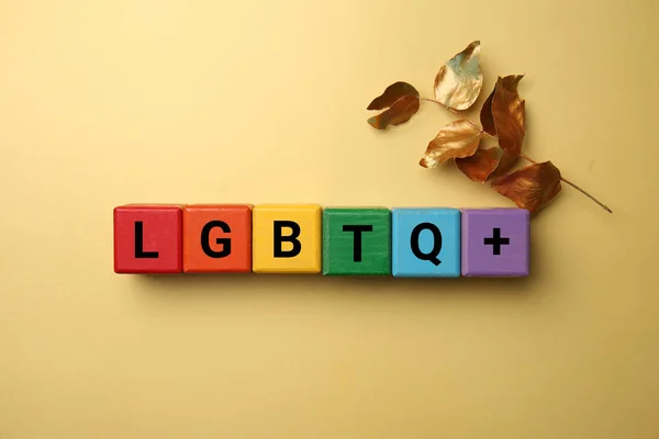 Cubes with abbreviation LGBTQ on color background — Stock Photo, Image
