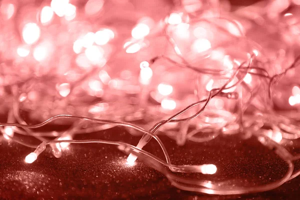 Glowing Christmas lights on dark background, closeup — Stock Photo, Image