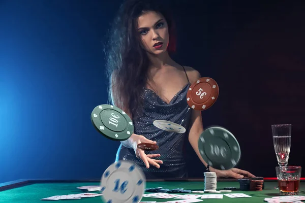 Красивая женщина-игрок бросает фишки за столом в казино — стоковое фото