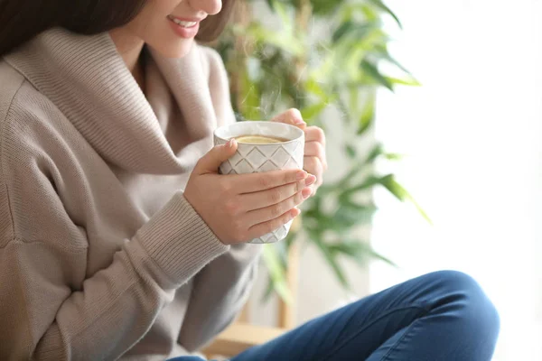 Beautiful young woman with cup of hot tea at home — Stock Photo, Image