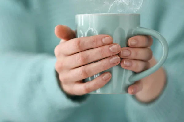 Young woman holding cup of hot coffee, closeup — Stock Photo, Image