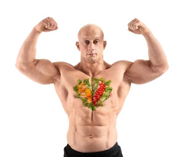 Muscular bodybuilder with painted vegetables on his chest against white background — Stock Photo, Image