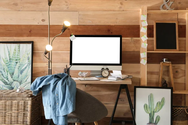 Stylish workplace with modern computer near wooden wall at home — Stock Photo, Image