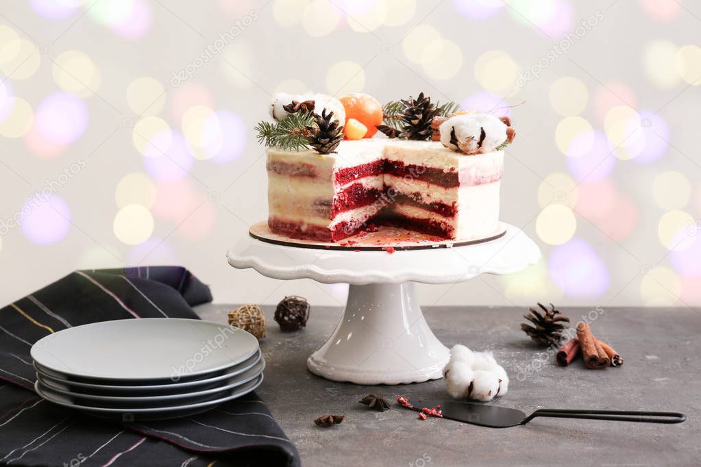 Stand with tasty Christmas cake on grey table