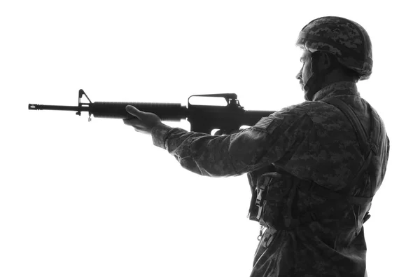 Silhouette of soldier in camouflage taking aim on white background — Stock Photo, Image