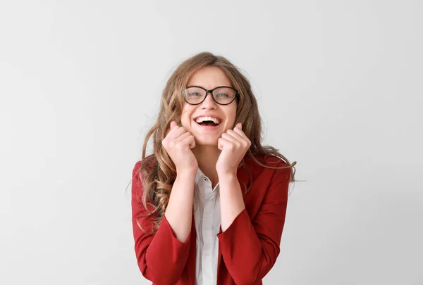 Portrait of happy young businesswoman on light background — Stock Photo, Image