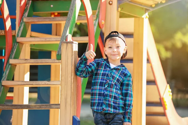 Cute little boy showing thumb-up gesture on play ground — Stock Photo, Image