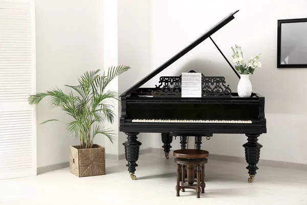 Black grand piano in interior of room