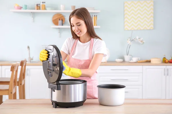 Woman cleaning modern multi cooker in kitchen — Stock Photo, Image