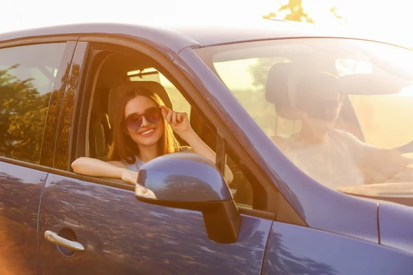 Happy couple sitting in their new car — Stock Photo, Image