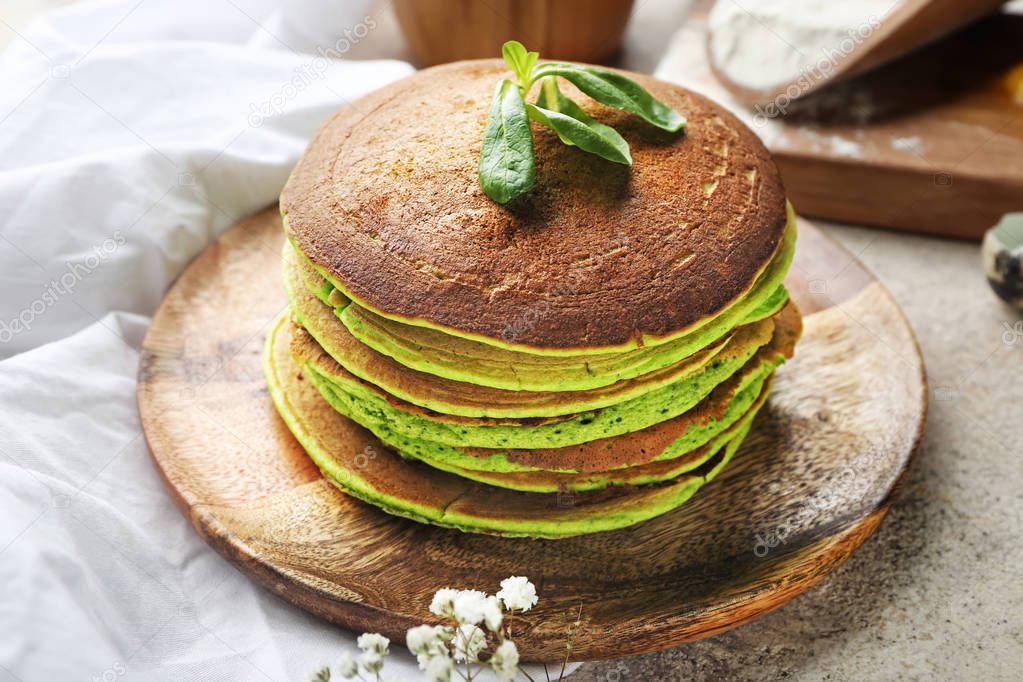 Tasty green pancakes on plate