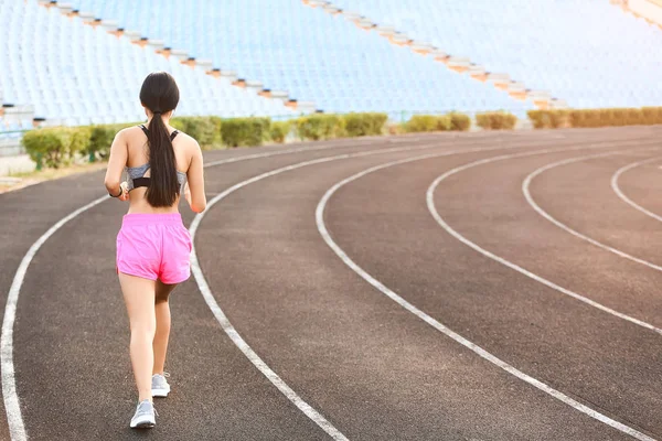 Sporty Asian woman running at the stadium — Stock Photo, Image