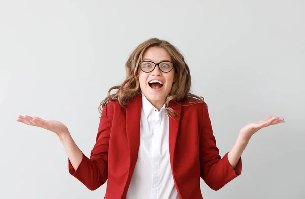 Portrait of happy young businesswoman on light background — Stock Photo, Image