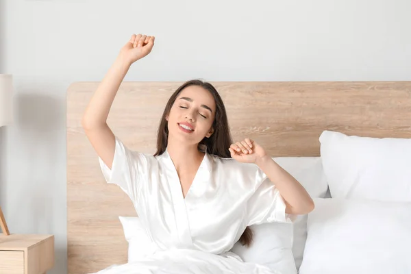 Ochtend van mooie jonge vrouw in de slaapkamer — Stockfoto