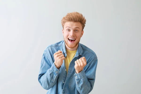 Happy young man on light background