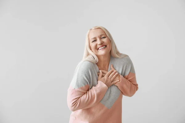 Mujer madura feliz sobre fondo gris —  Fotos de Stock