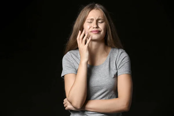 Stressed young woman on dark background — Stock Photo, Image