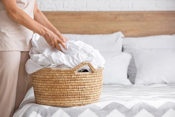 Woman with laundry in bedroom — Stock Photo, Image