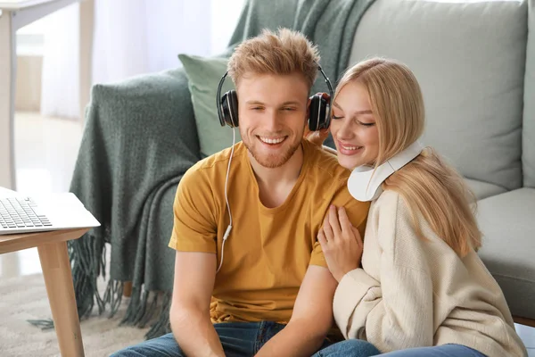 Young couple listening to music at home