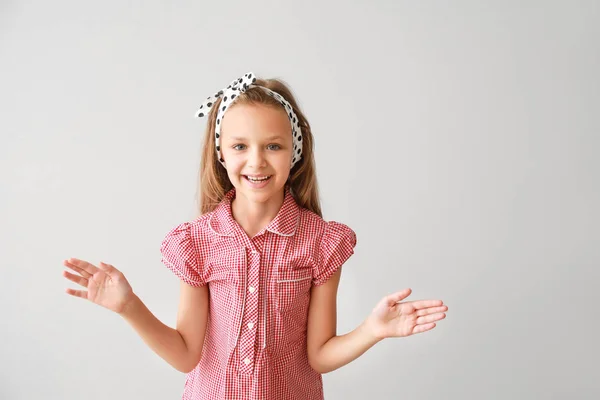 Portrait of happy little girl on light background — Stock Photo, Image