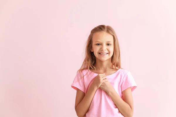 Portrait of happy little girl on color background — Stock Photo, Image