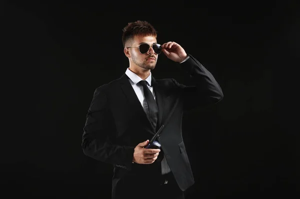 Handsome security guard on dark background — Stock Photo, Image