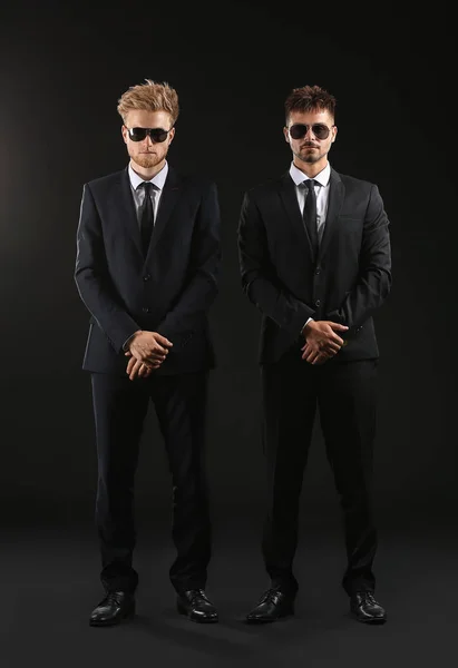 Handsome security guards on dark background — Stock Photo, Image