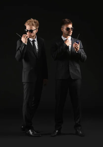 Handsome security guards on dark background — Stock Photo, Image