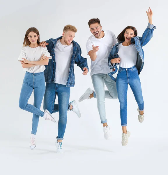 Grupo de jóvenes saltando en ropa casual con estilo sobre fondo blanco — Foto de Stock