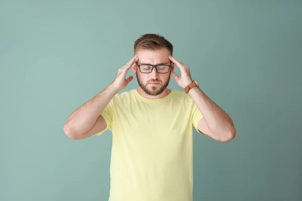 Stressed young man on color background