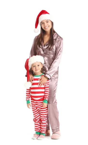 Woman and her little daughter in Santa hats on white background — Stock Photo, Image