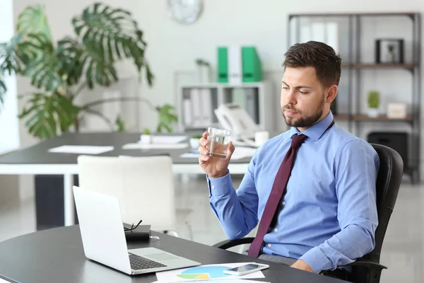 Portrait of businessman drinking water in office — Stock Photo, Image