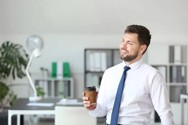 Portrait of businessman with cup of coffee in office — Stock Photo, Image