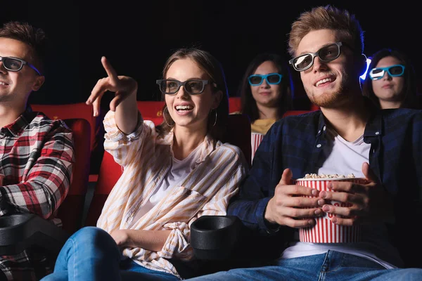 Friends with popcorn watching movie in cinema — Stock Photo, Image