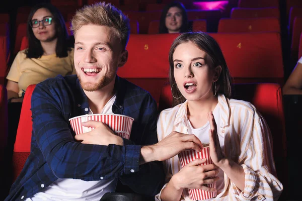 Couple with popcorn watching movie in cinema — Stock Photo, Image