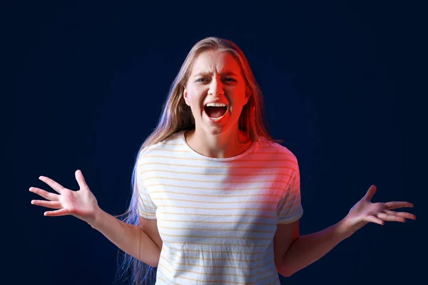 Portrait of angry woman on dark background — Stock Photo, Image
