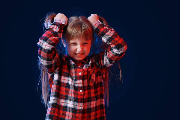 Portrait of angry little girl on dark background — Stock Photo, Image