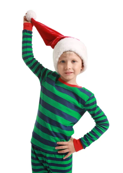 Bonito menino de pijama e chapéu de Papai Noel no fundo branco — Fotografia de Stock