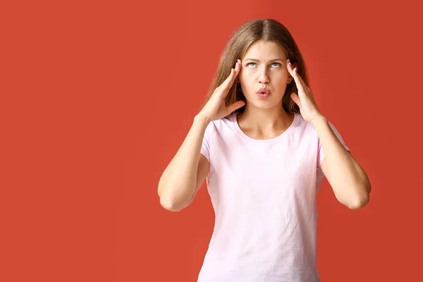 Stressed young woman on color background — Stock Photo, Image