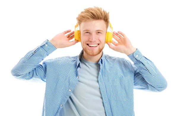 Knappe jongeman, luisteren naar muziek op witte achtergrond — Stockfoto